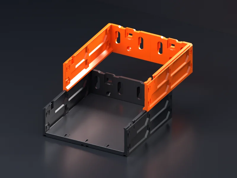 An orange Case Extender, a case with no floor, sitting part-way back on a black case: the case below slides in under it from the front