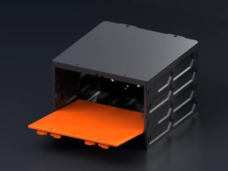 An orange Shelf Insert held just above the floor of an open black bay, its back edge dipped, sliding in from the front