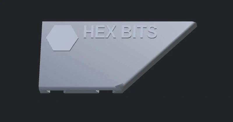 The same HEX BITS label with pale gray text on a gray label: the raised text barely shows
