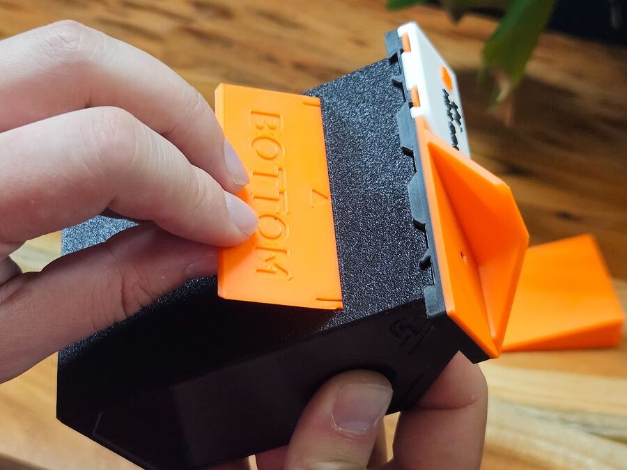 Inserting the screw-hole cover through the bottom slot, BOTTOM text facing down