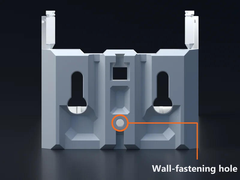 The back of a white 1W-1H case seen straight on: two keyhole peg slots, and between them, low on the back wall, a small round hole ringed in orange and labeled wall-fastening hole