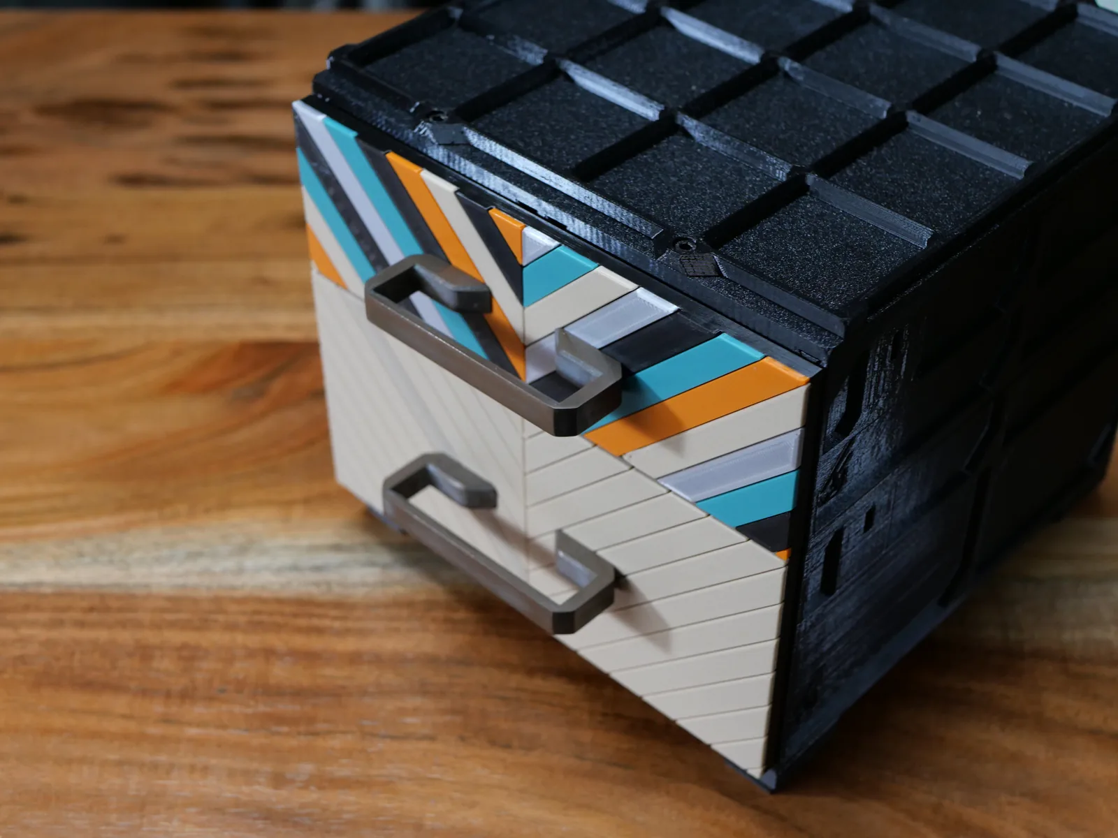 A Chevron faceplate with teal, orange, cream and gray strips above a plain tan one