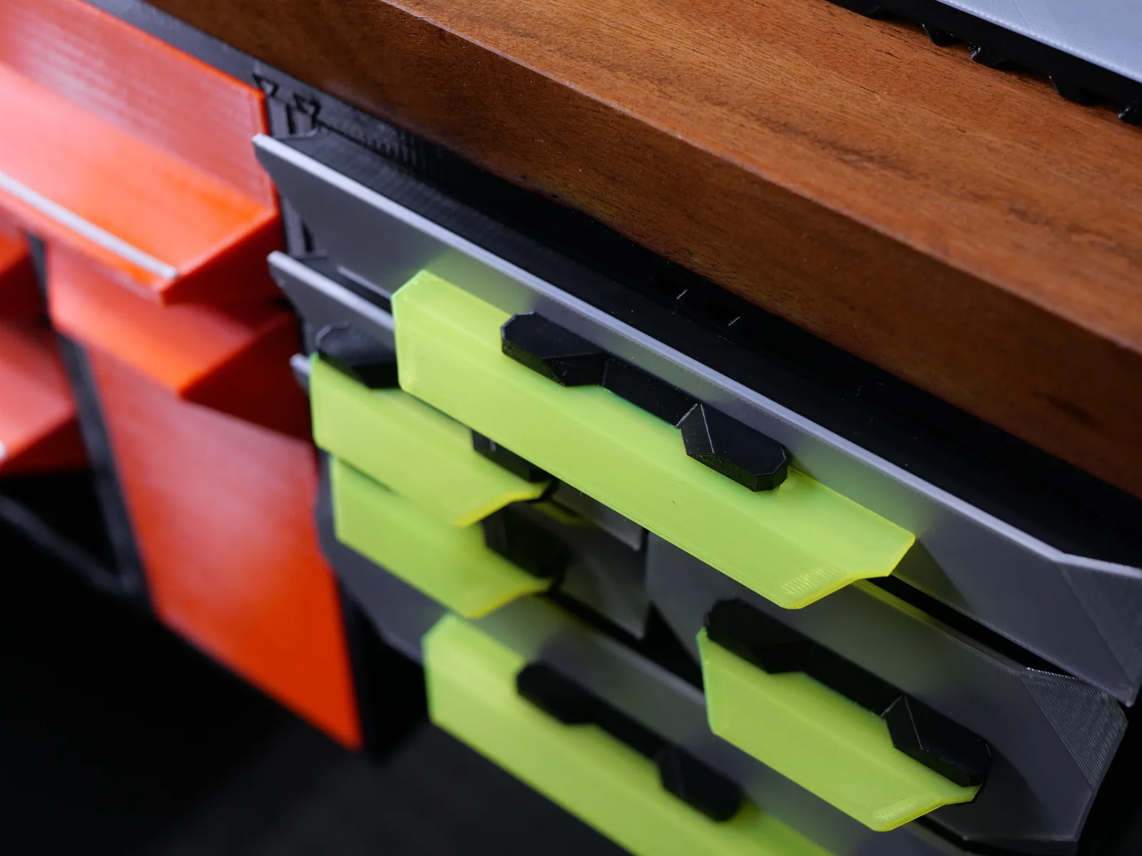 Yellow-green Crystal handles on gray drawers mounted under a wooden desk