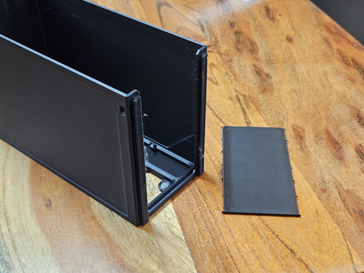 The same drawer with its front open, the removed tear-away panel lying beside it