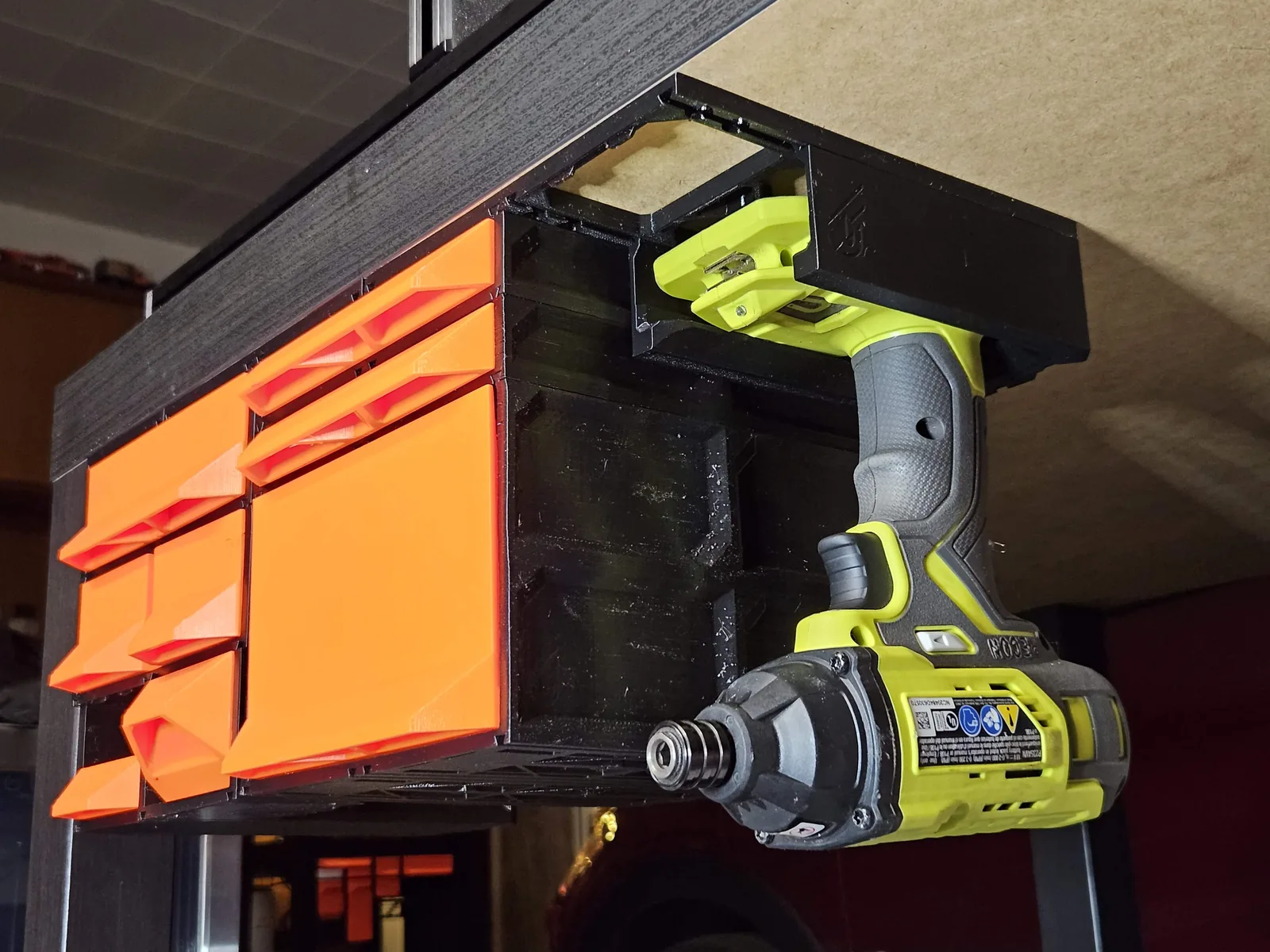 An under-cabinet workshop build: drawers, and a power tool hanging on its own holder.